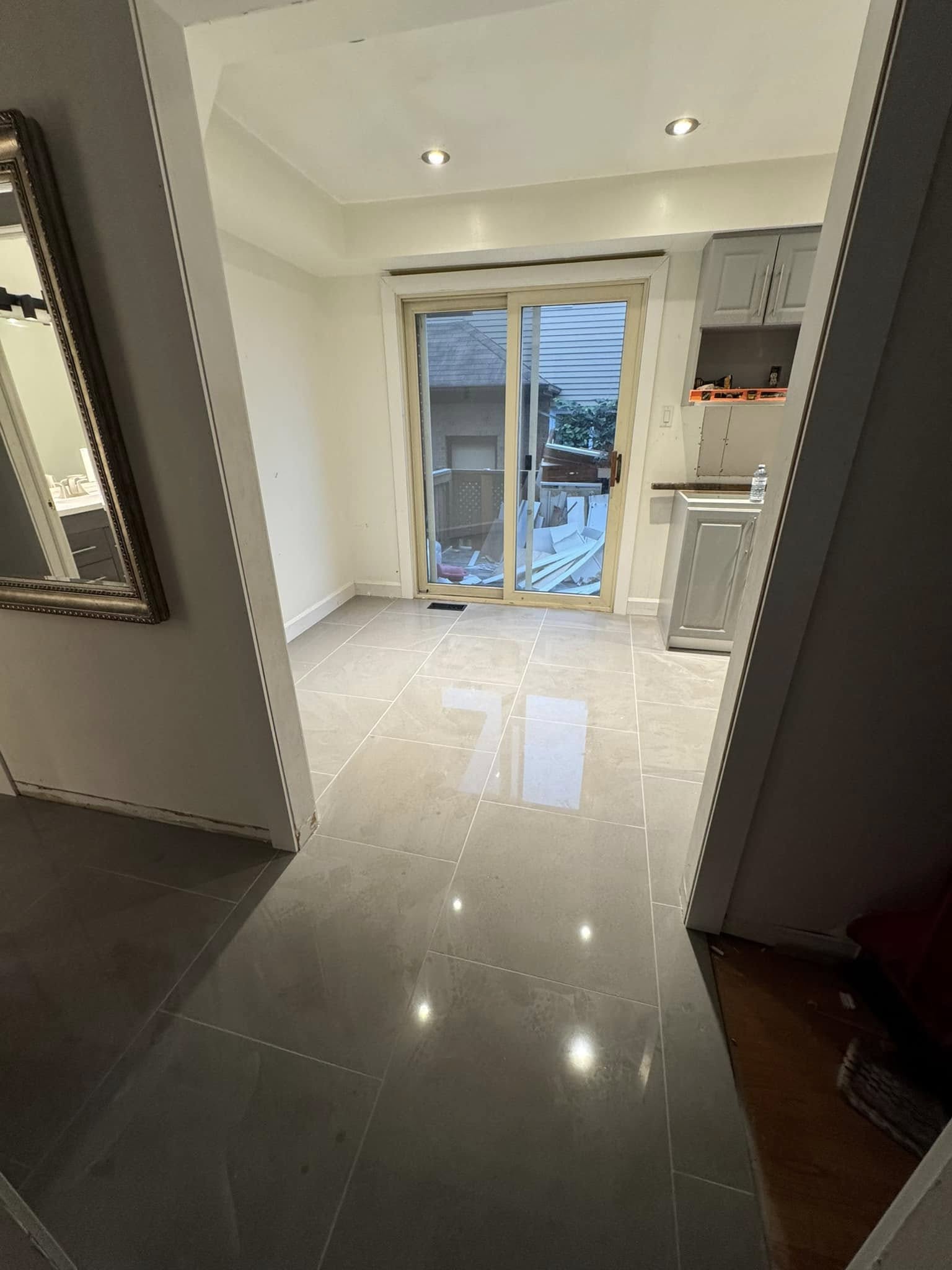 Hallway with new glossy large-format floor tile.